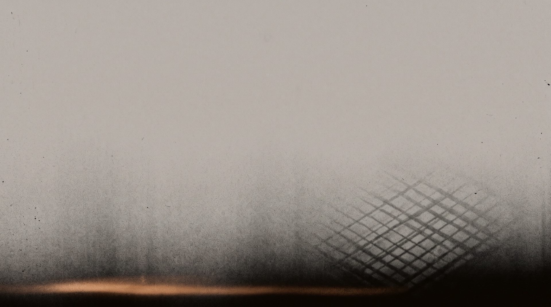 Photogram: the same paper drained to flat grey, the grating dissolving and one last warm line of light along the floor.